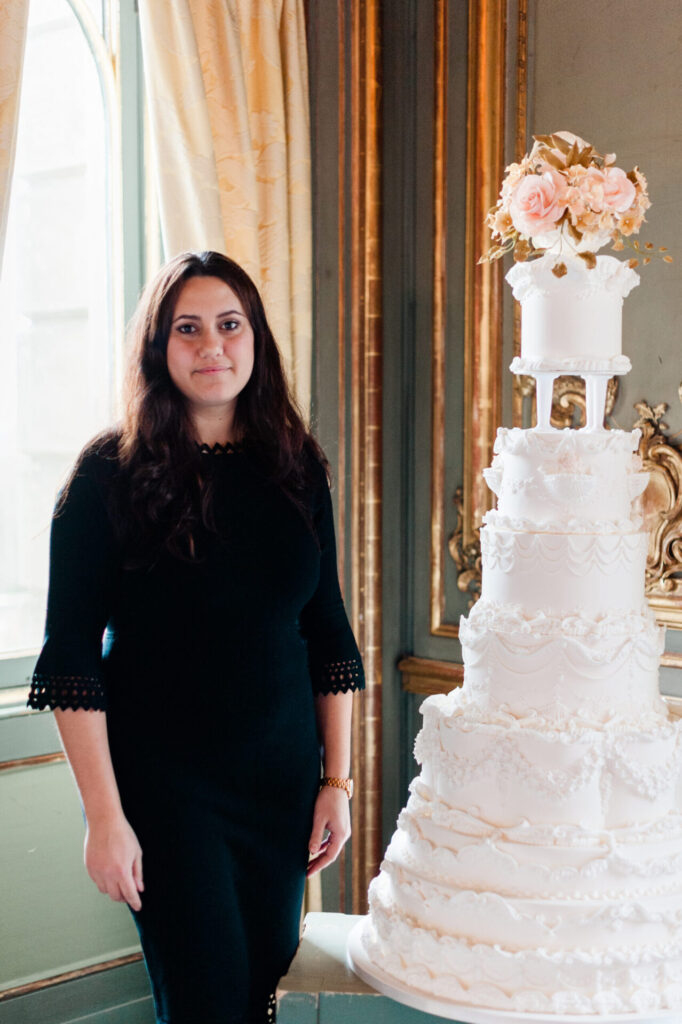 Yevnig Davis, Unique bespoke luxury wedding Cakes by Yevnig, standing next to one of her cakes