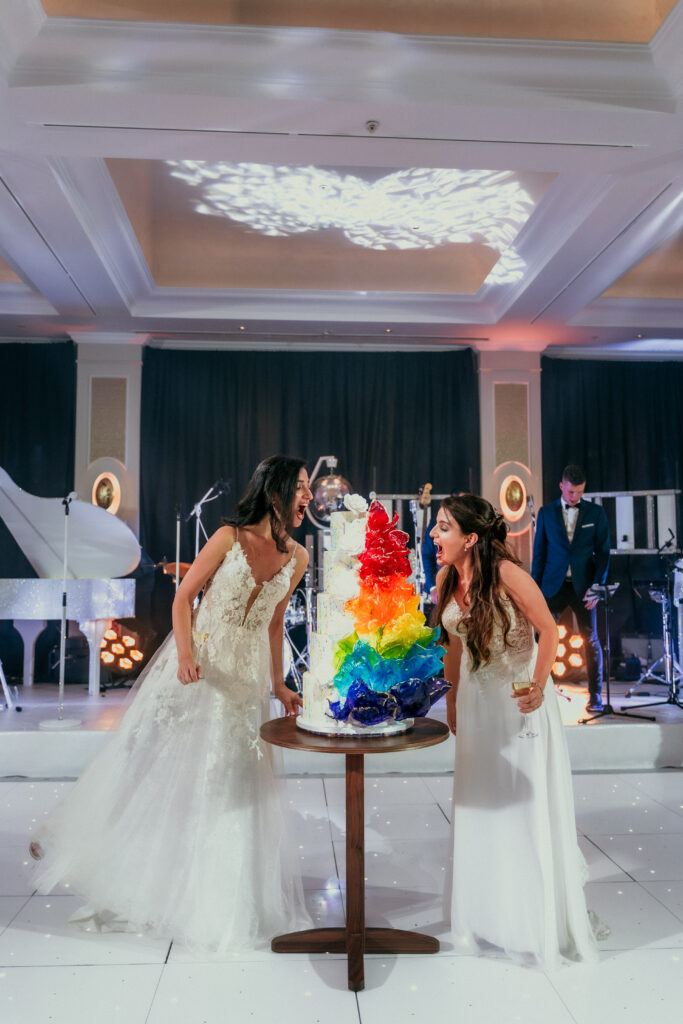 Same sex couple with rainbow pride luxury wedding cake by Yevnig