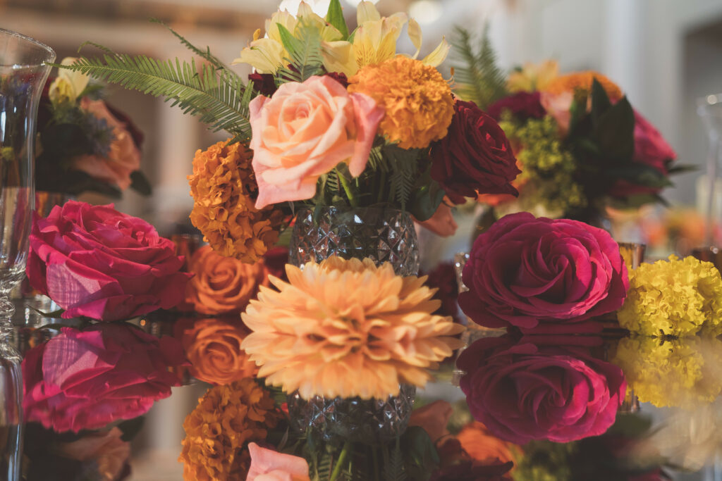 Bright table florals by Simon Lycett decorating By Yevnig luxury wedding cake at Historic Royal Palaces Banqueting house