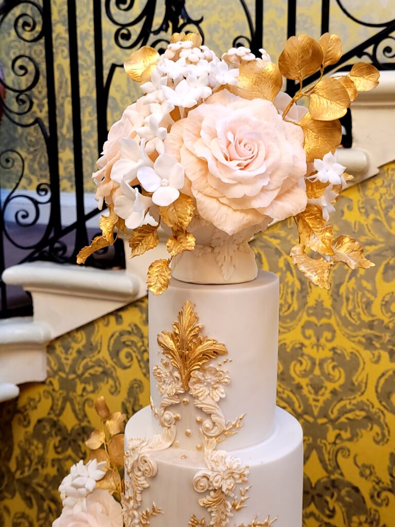 Beautiful sugar flower bouquet on top of luxury By Yevnig wedding cake