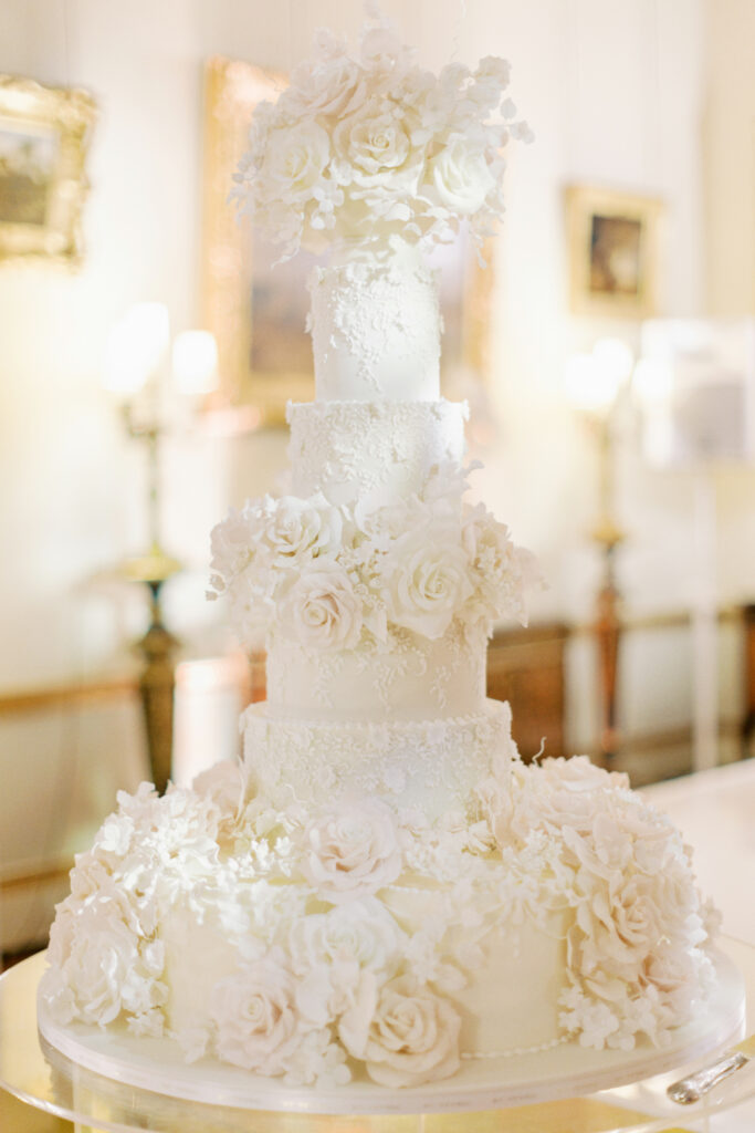 Regal seven-tier laurel and lace fairytale wedding cake By Yevnig at Somerley House Events photographed by Jacob & Pauline Photography, planned by Luxus Events in Hampshire Countryside Wedding