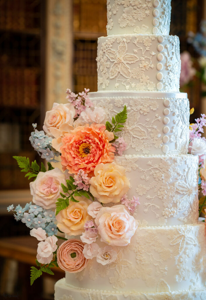 By Yevnig luxury wedding cake detailed image of the applique lace and floral decoration captured by Royal photographer Hugo Burnand
