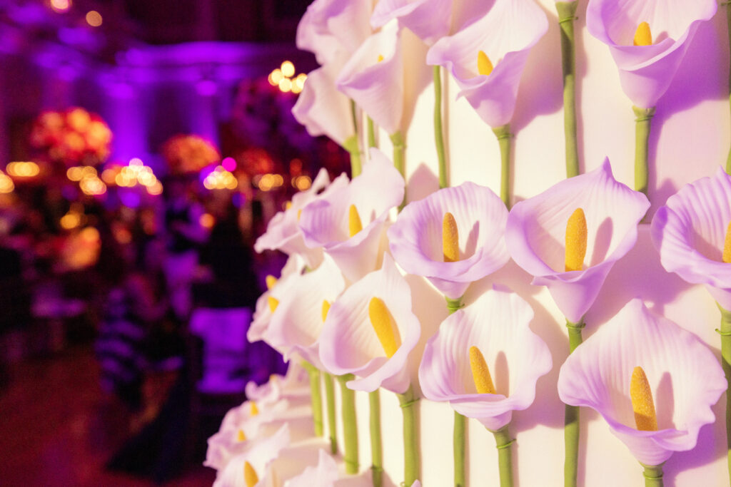 close-up of contemporary wedding cake By Yevnig decorated with sugar-crafted cala lilies]