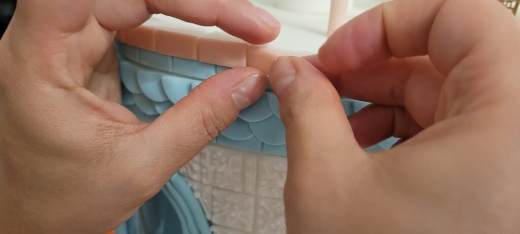 Yevnig Davis adding hand constructed tiles to The Wedding Cake, By Yevnig
