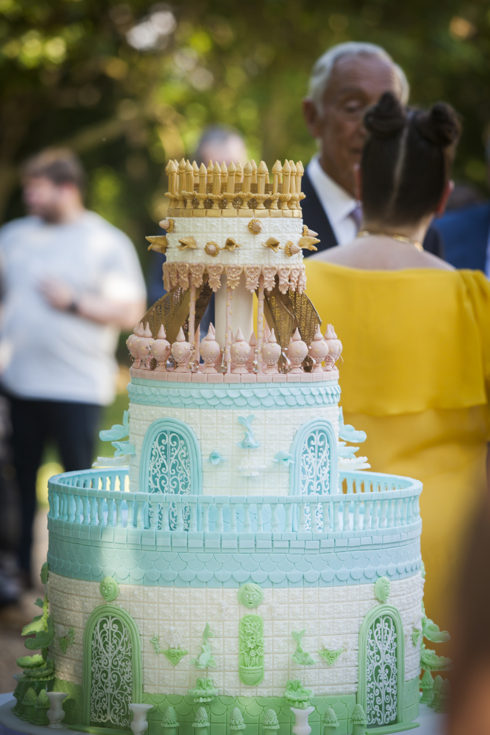 The Wedding Cake By Yevnig at Waddesdon Manor, sits in the fore-front of the image with Lord Rothschild and Joana Vasconcelos standing behind.