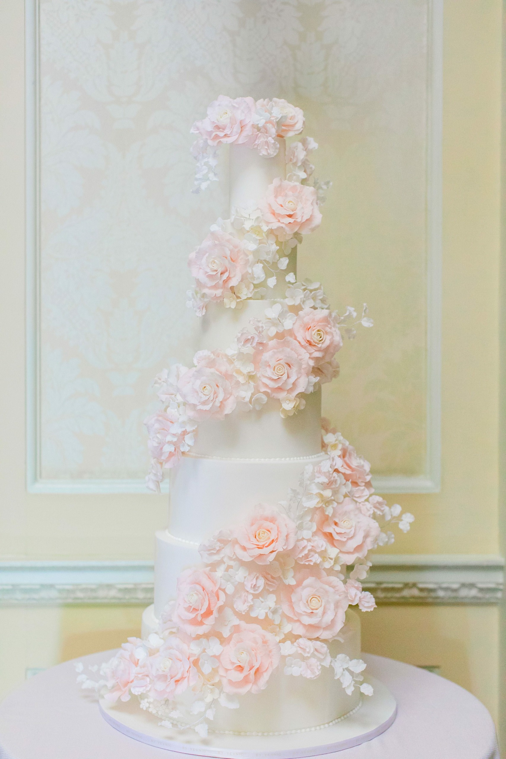 Roses and Blooms By Yevnig 7 tier floral classic cascade wrap white wedding cake at Hedsor House Berkshire